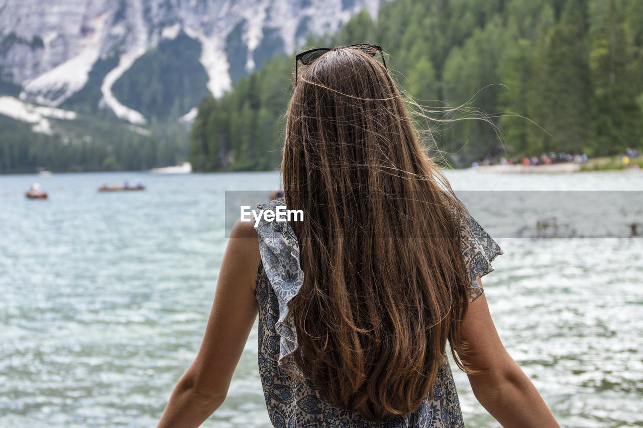 Rear view of woman standing in water