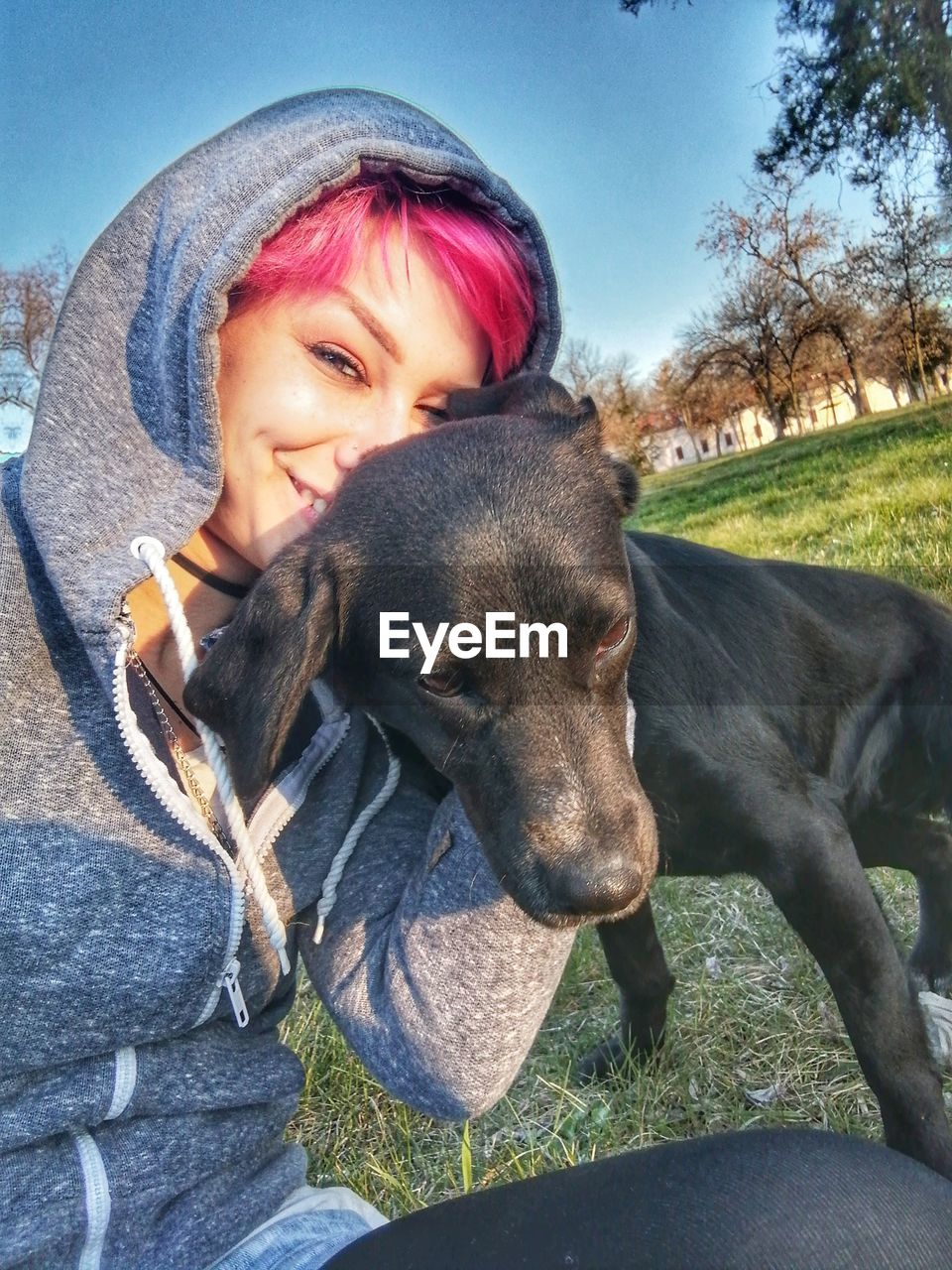 PORTRAIT OF GIRL WITH DOG ON FIELD