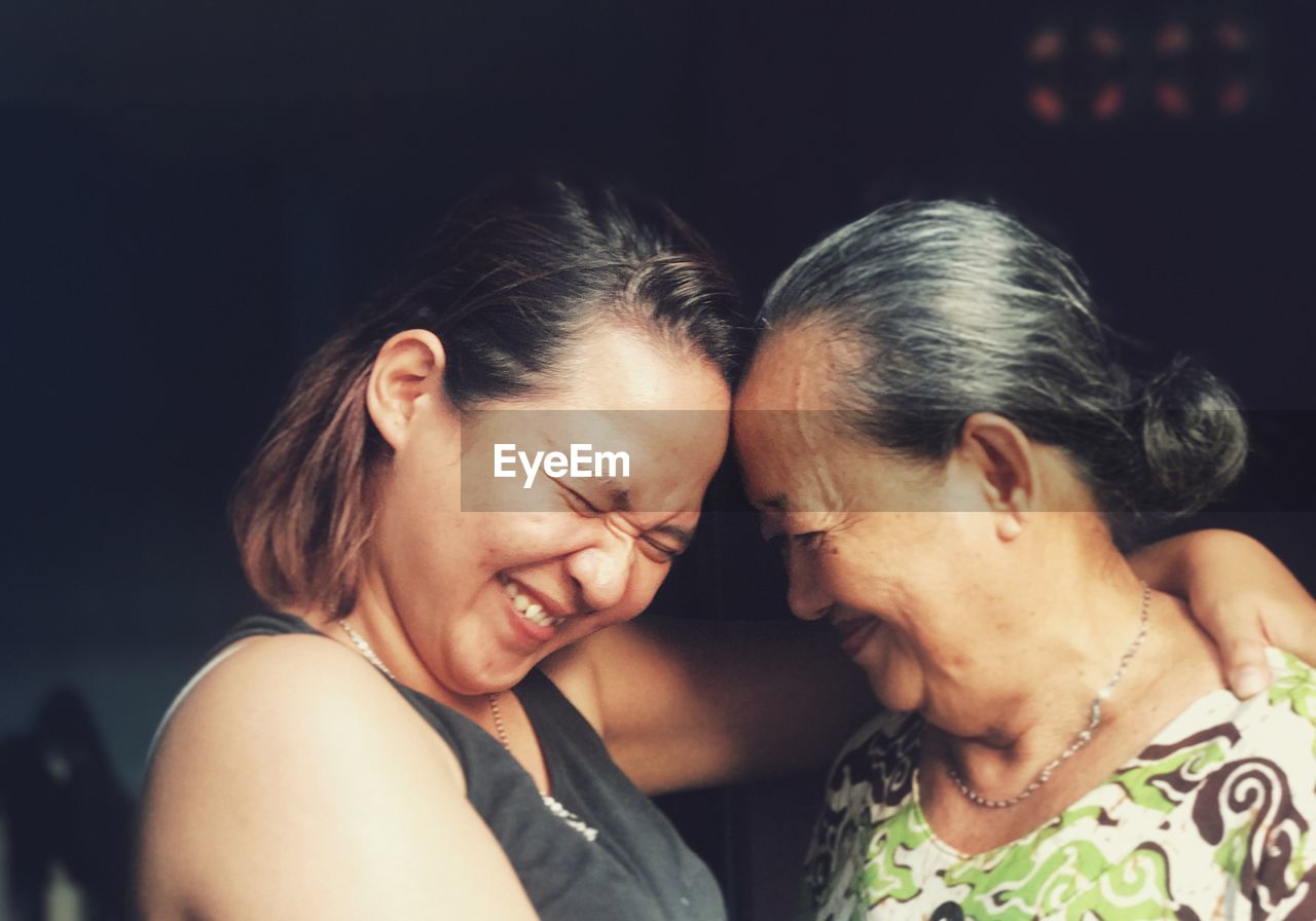 Smiling mother and daughter embracing