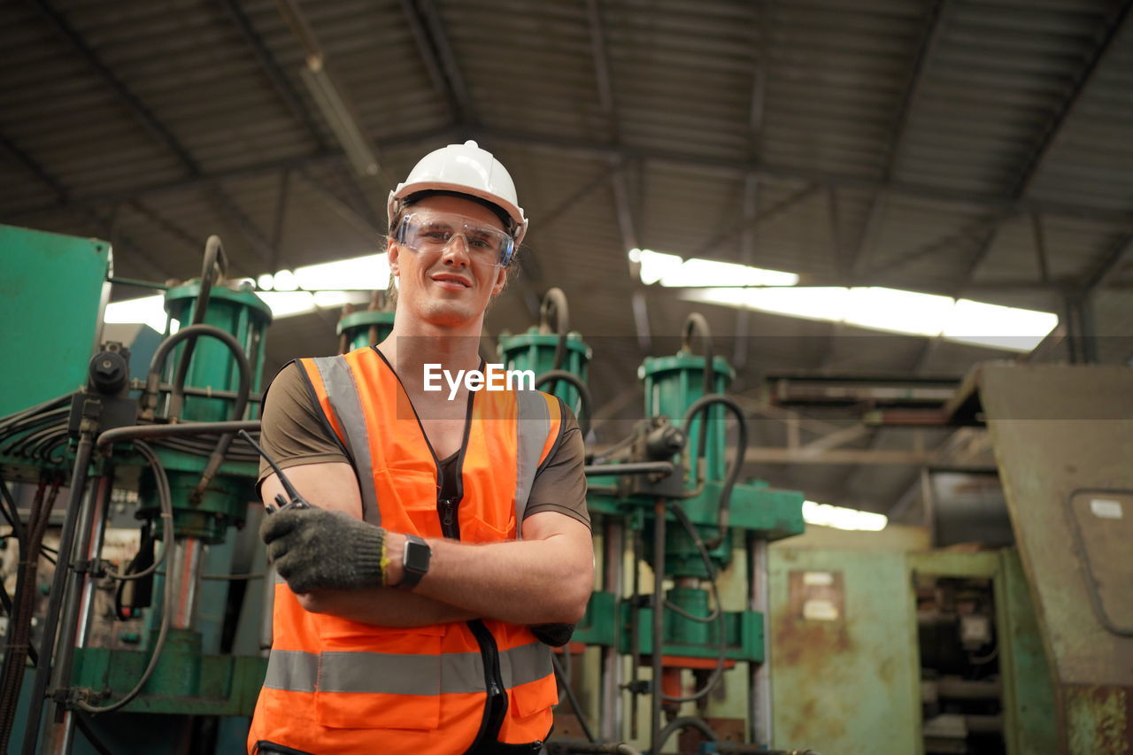 portrait of man standing in factory
