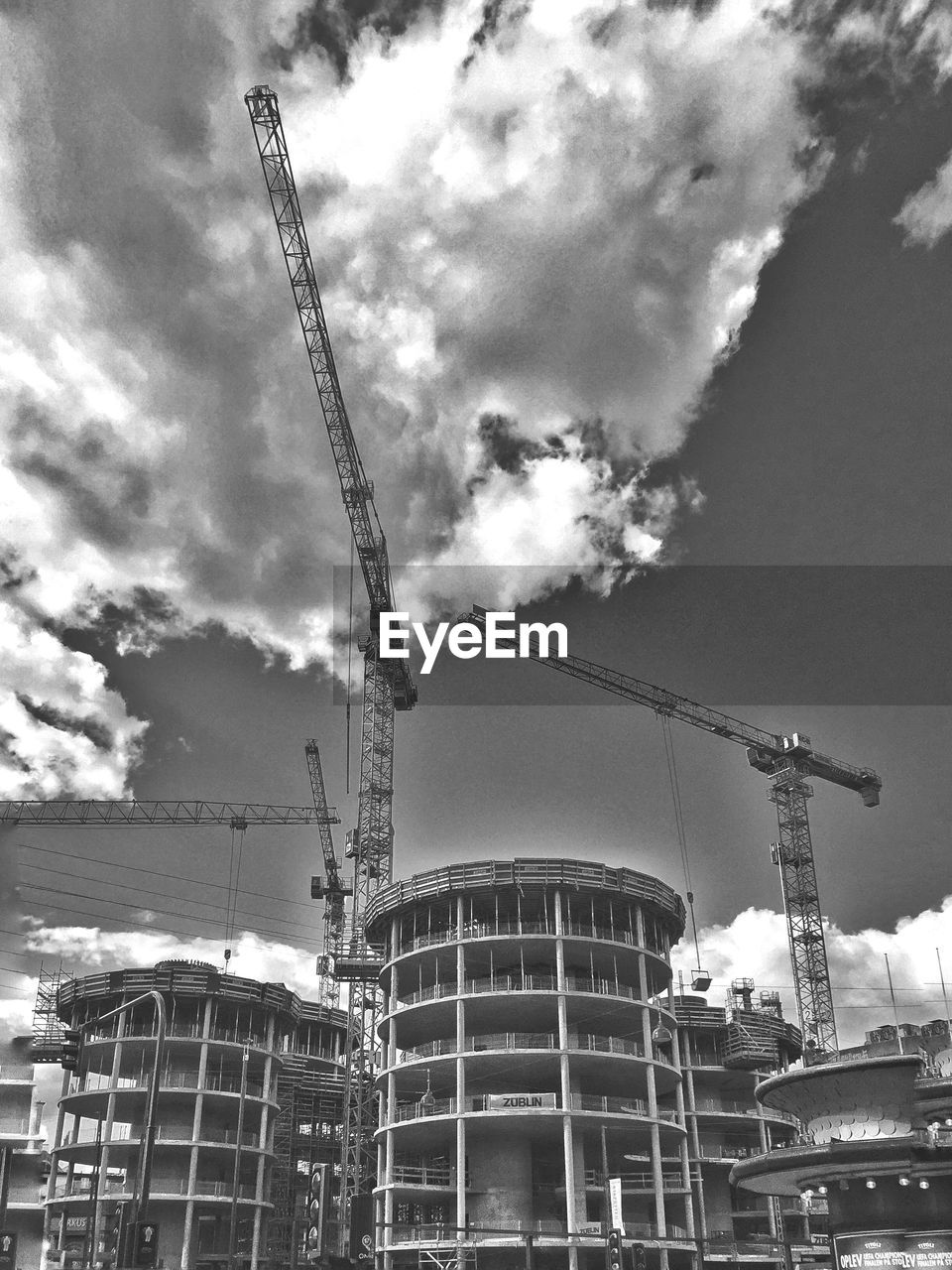 LOW ANGLE VIEW OF CRANE AND CRANE AGAINST SKY