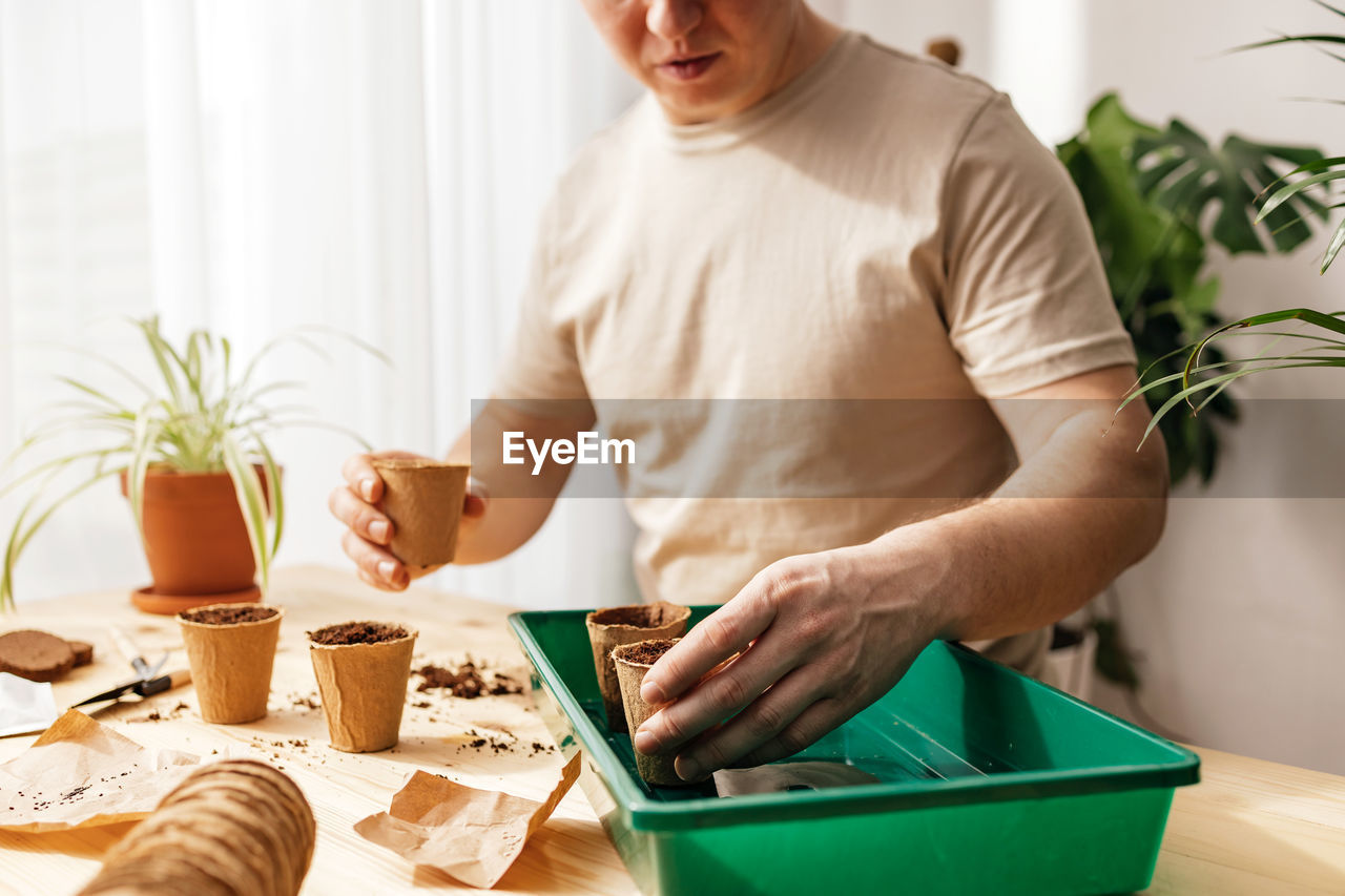 portrait of young man preparing food on table