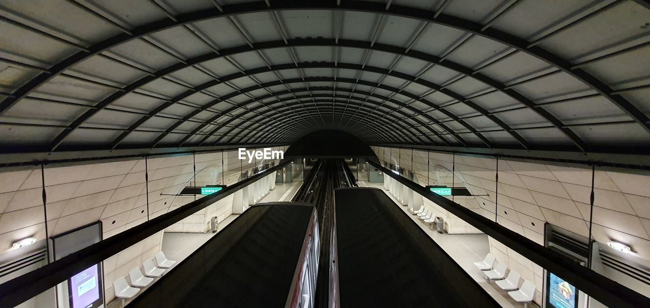 LOW ANGLE VIEW OF ESCALATORS IN SUBWAY STATION