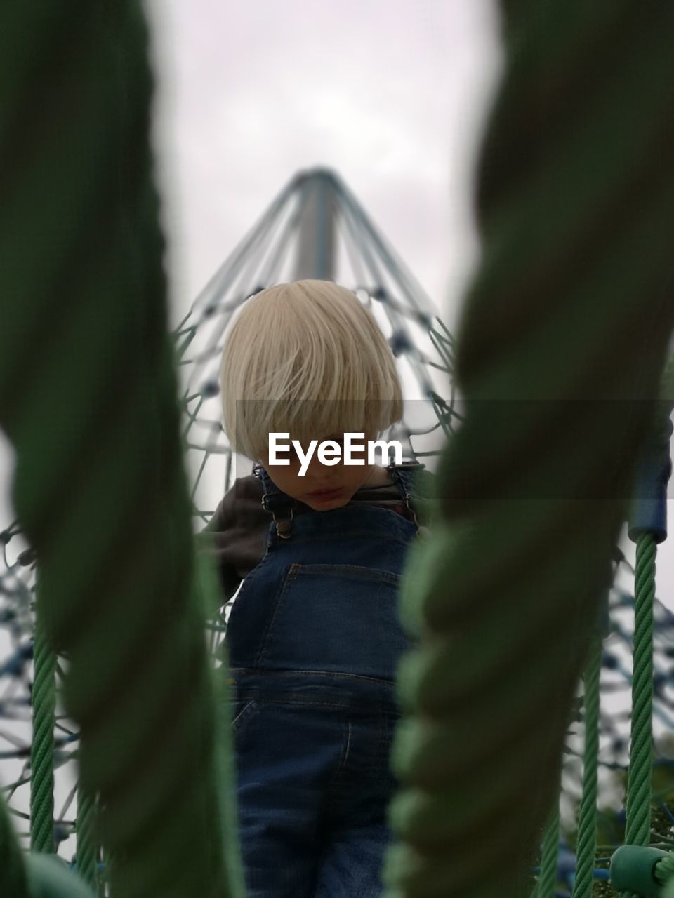 Rear view of girl on slide at playground