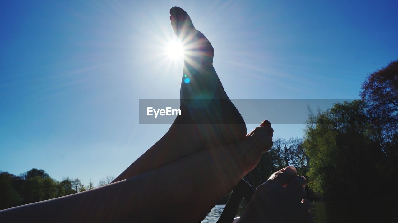 LOW ANGLE VIEW OF SILHOUETTE HAND STATUE AGAINST SKY ON SUNNY DAY