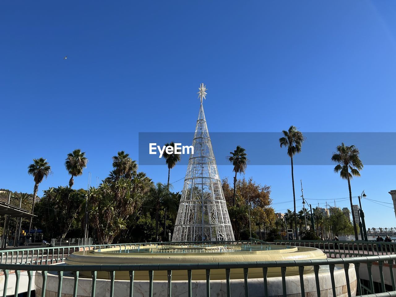 architecture, landmark, sky, tree, travel destinations, built structure, palm tree, plant, nature, travel, blue, tourism, tropical climate, clear sky, city, building exterior, no people, history, the past, water, outdoors, tower, sunny, cityscape, day, monument, memorial