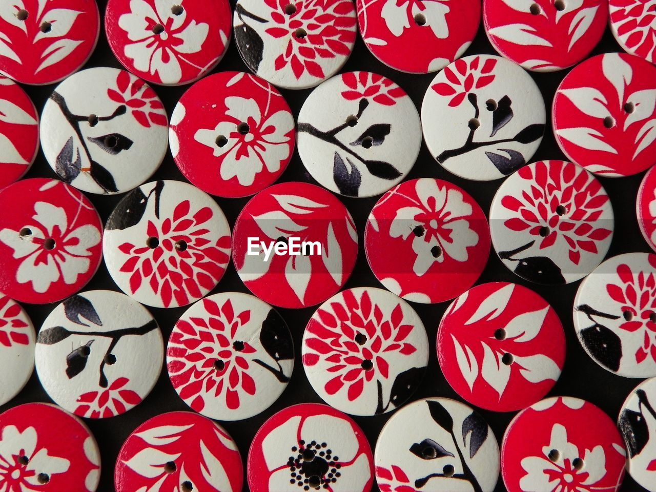 Full frame view of circular buttons with floral pattern