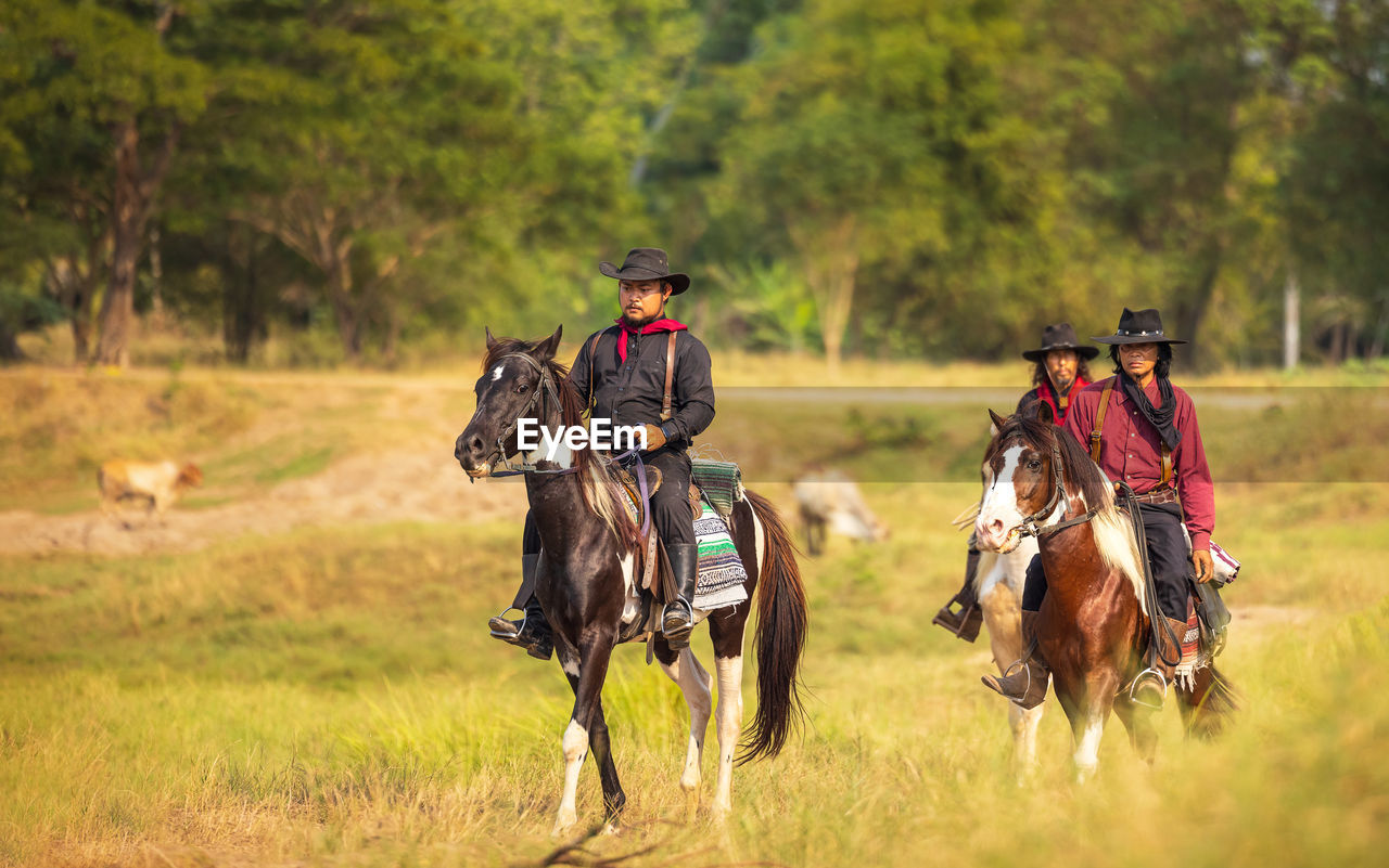 Cowboy's way of life include riding a horse around locales.