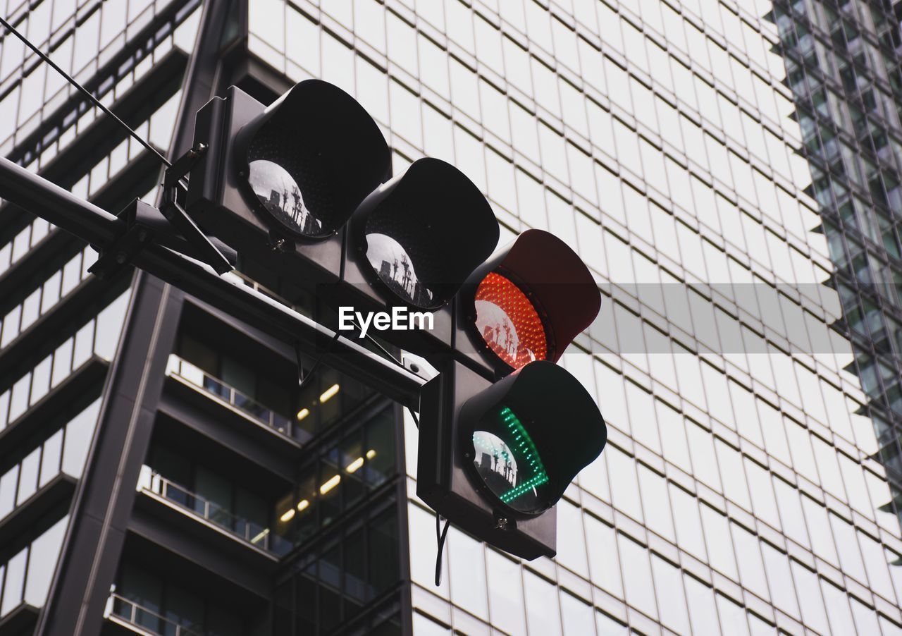 Low angle view of traffic light against building