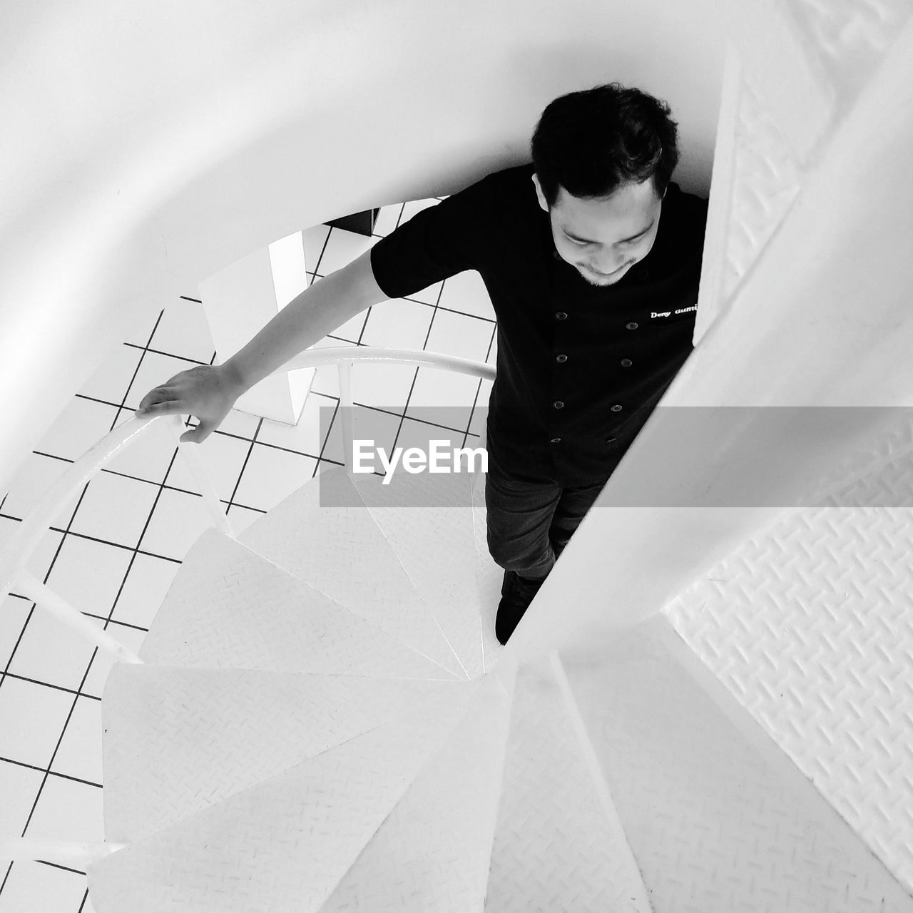 High angle view of boy standing on paper