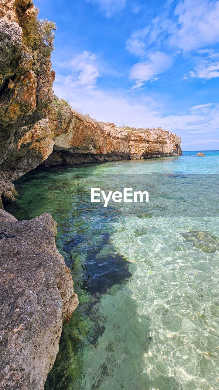 water, sea, land, scenics - nature, rock, sky, beauty in nature, beach, nature, coast, shore, body of water, travel destinations, travel, environment, blue, cloud, landscape, ocean, tranquility, cliff, coastline, rock formation, bay, tranquil scene, no people, terrain, tourism, idyllic, holiday, outdoors, trip, vacation, seascape, cove, island, turquoise colored, day, non-urban scene, horizon, lagoon, horizon over water, tropical climate, sunlight, bay of water, islet, summer, sand
