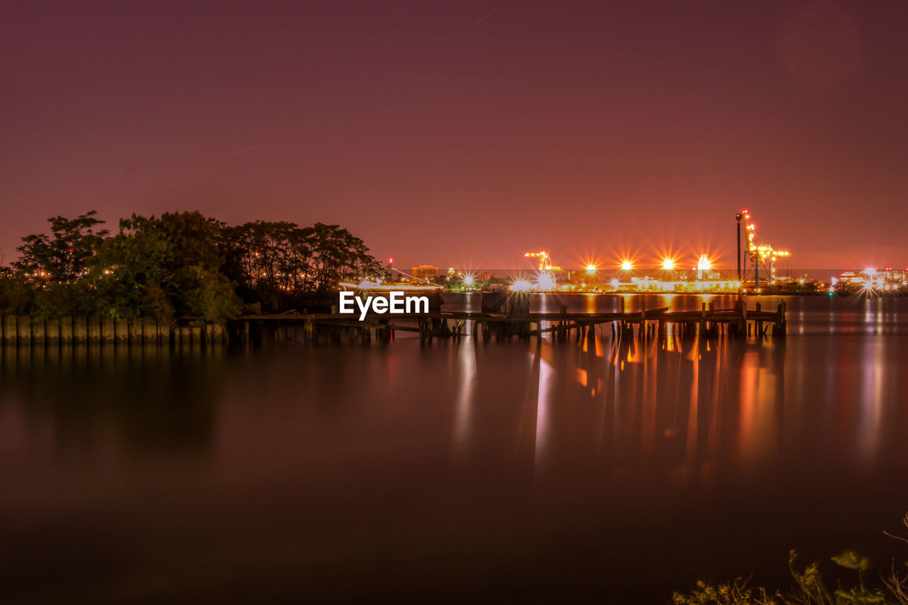 Reflection of illuminated buildings in sea at night