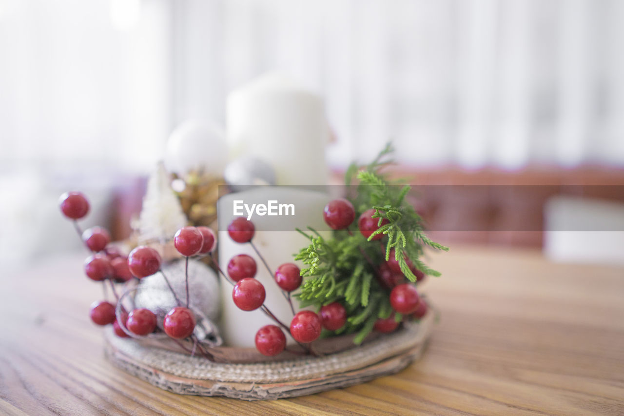 Close-up of candle in plate on table