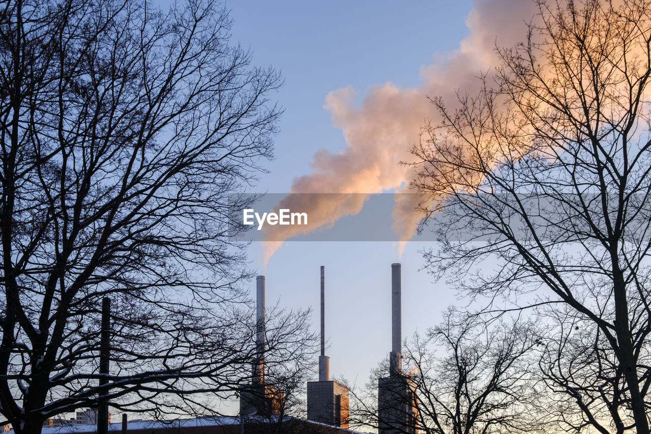 Smoke emitting from chimney against sky