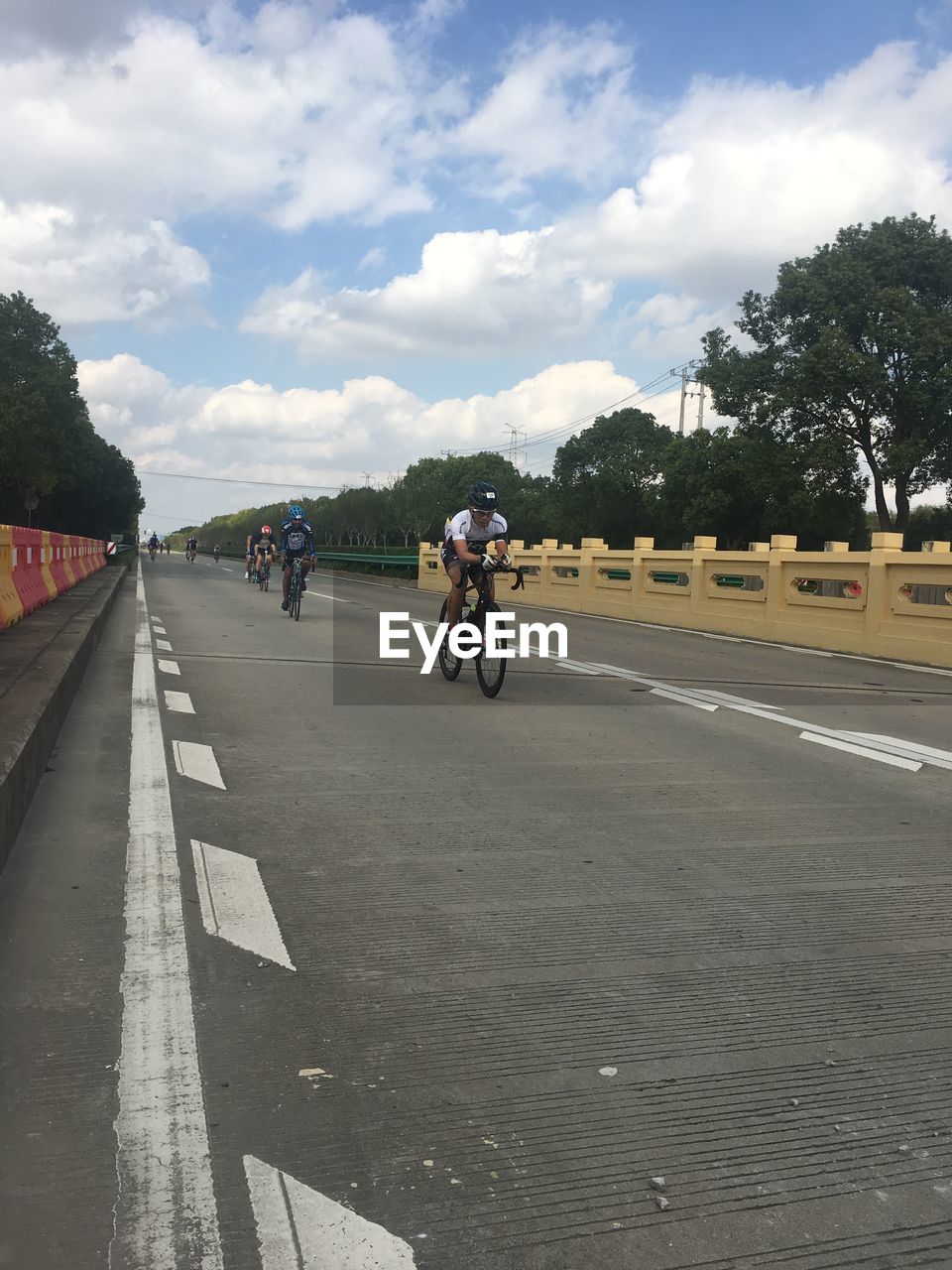 MAN RIDING BICYCLE ON ROAD