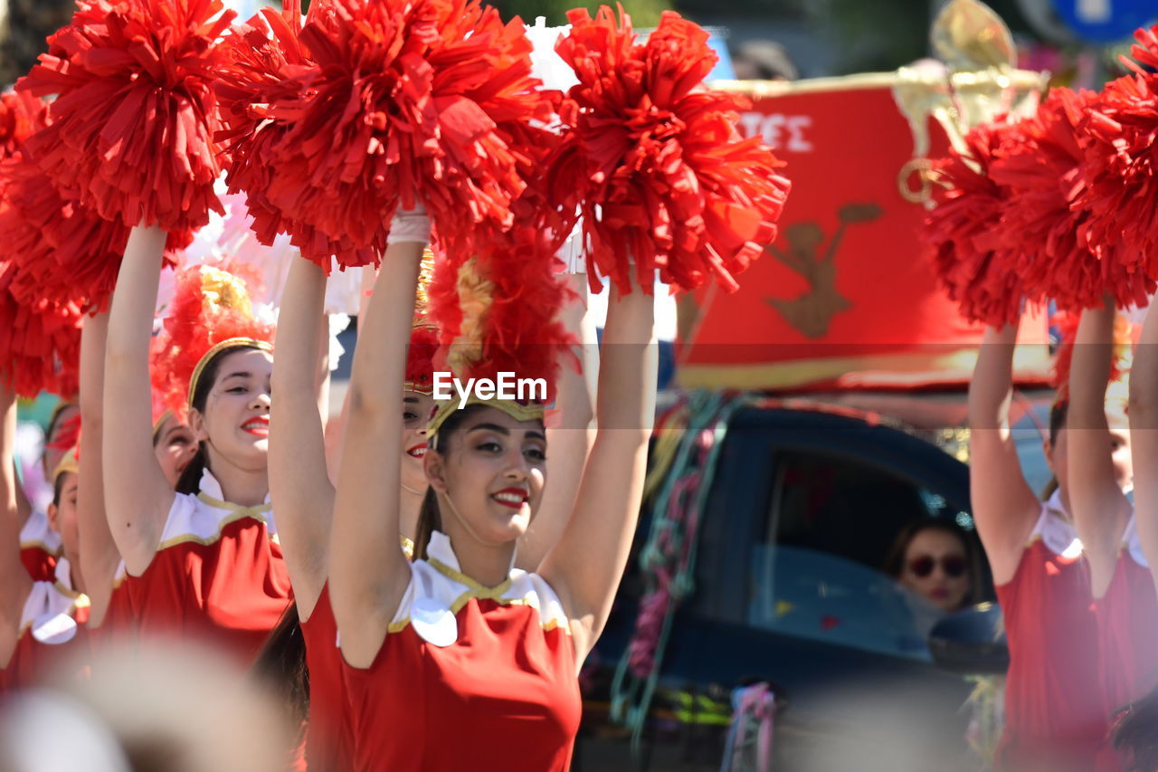 REAR VIEW OF PEOPLE AT RED TRADITIONAL CLOTHING