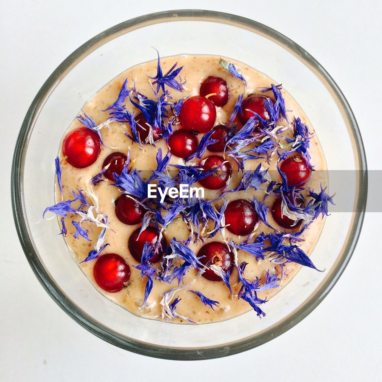 Directly above view of red currant smoothie against white background