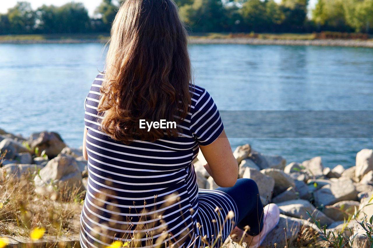 Rear view of woman looking at view of lake