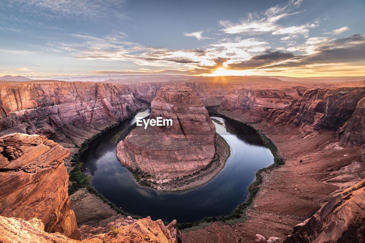 High angle view of horseshoe bend against sky during sunset