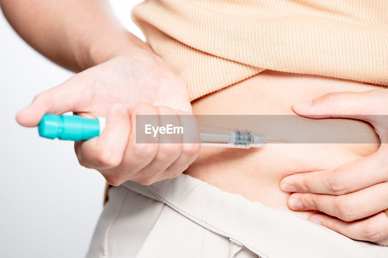 midsection of doctor giving syringe