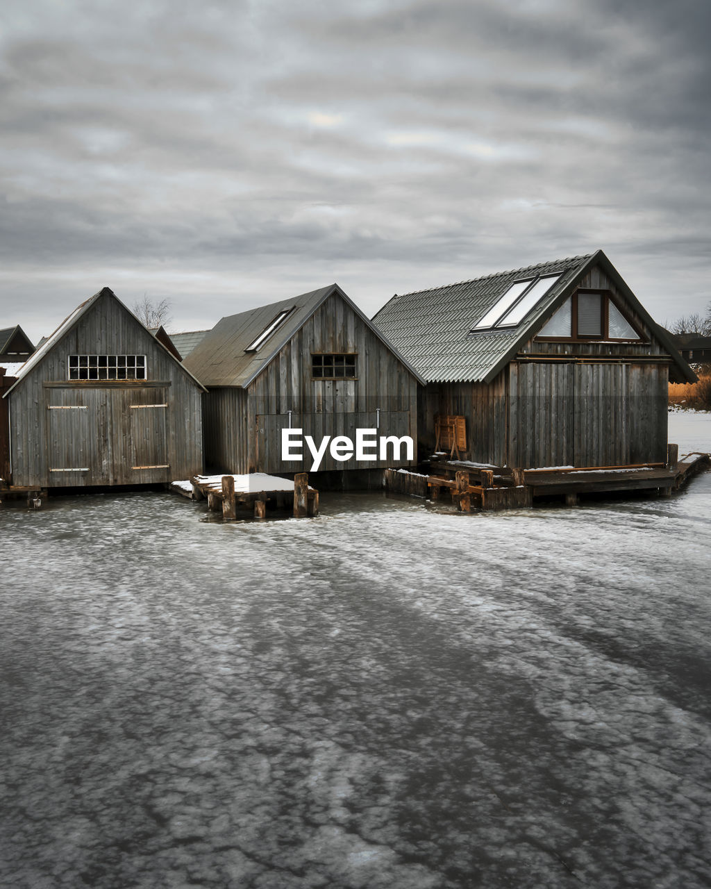 architecture, built structure, building exterior, building, winter, cloud, snow, sky, house, nature, hut, water, no people, wood, home, residential district, day, outdoors, shack, stilt house, environment, landscape, land