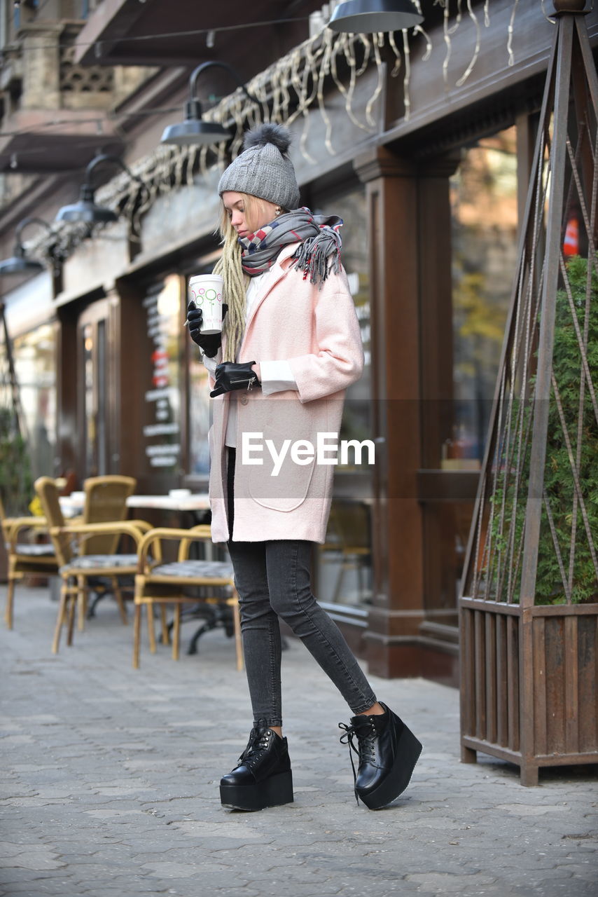 Full length of woman standing in city