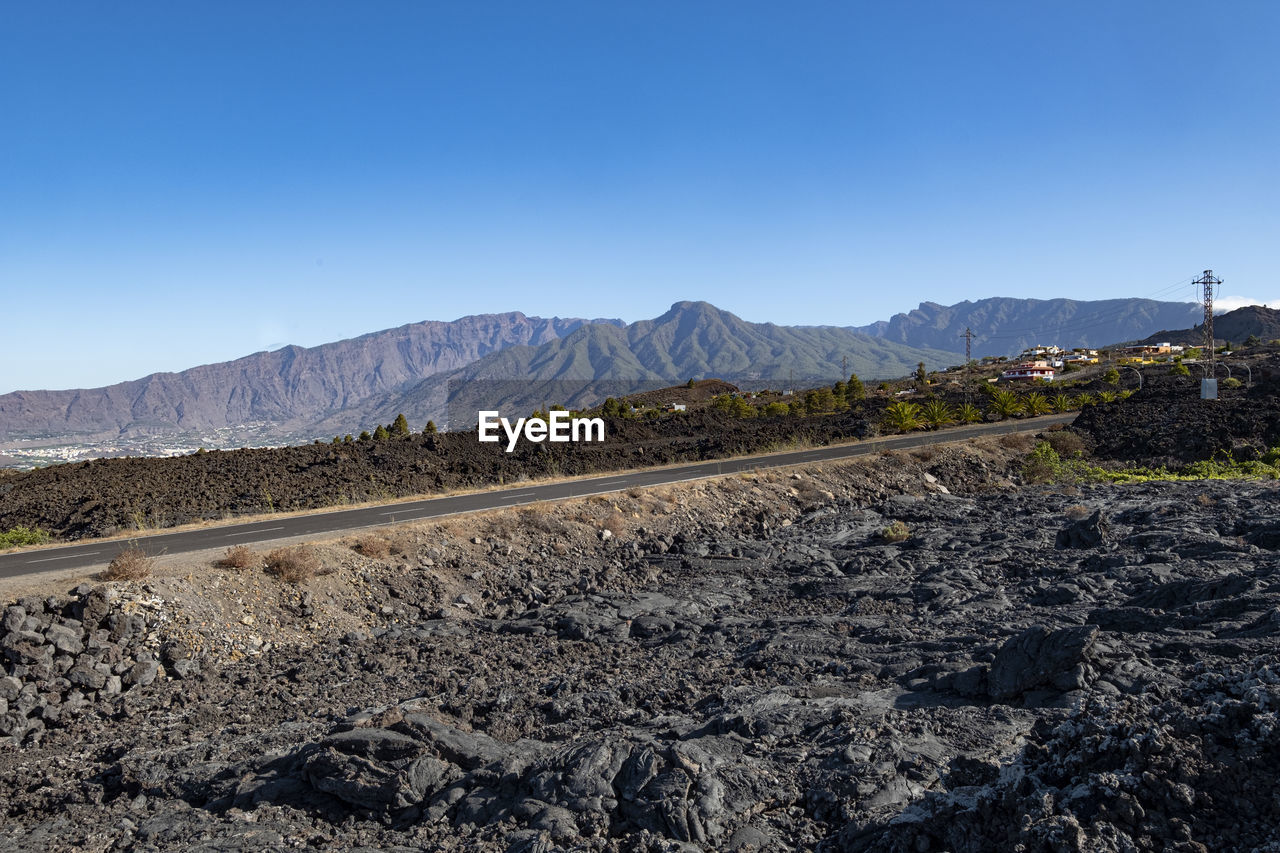 SCENIC VIEW OF MOUNTAINS AGAINST BLUE SKY