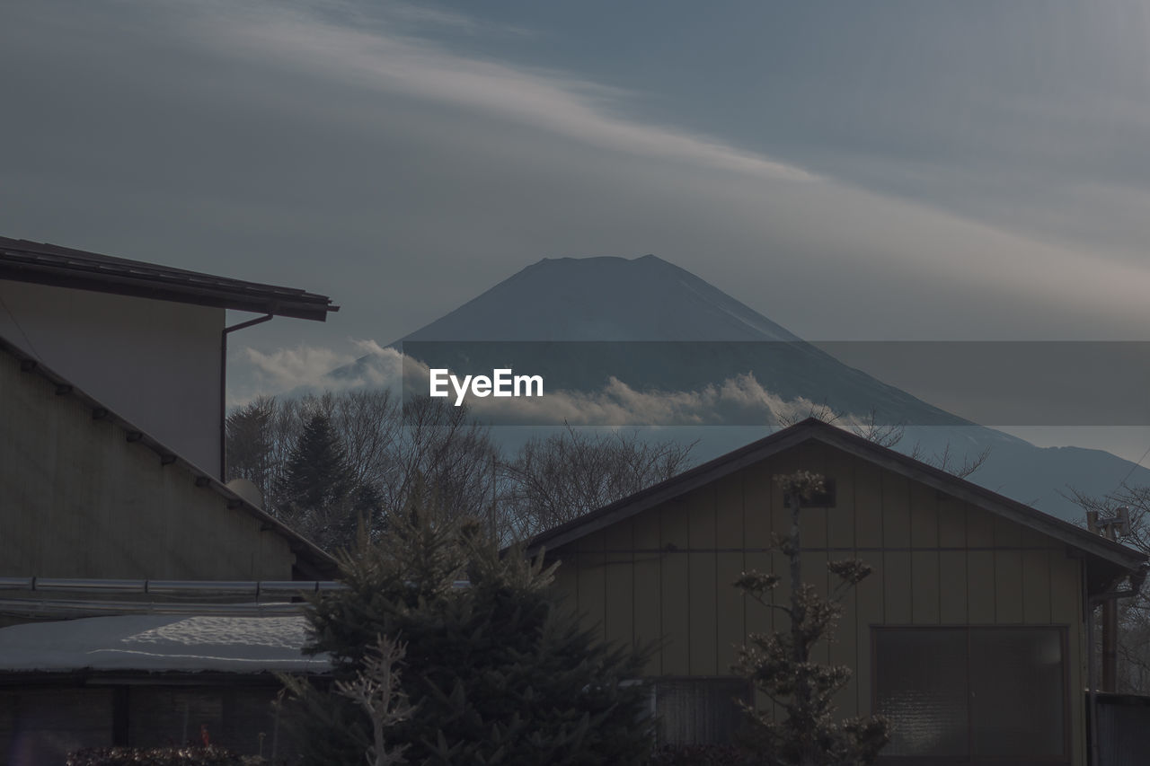 HOUSE ON SNOWCAPPED MOUNTAIN AGAINST SKY