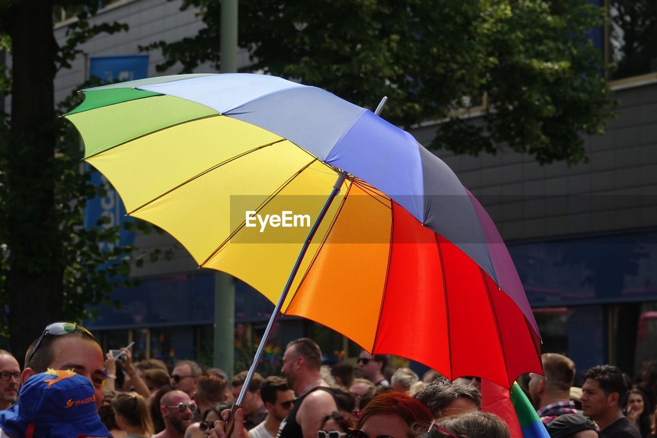 GROUP OF PEOPLE ON UMBRELLA