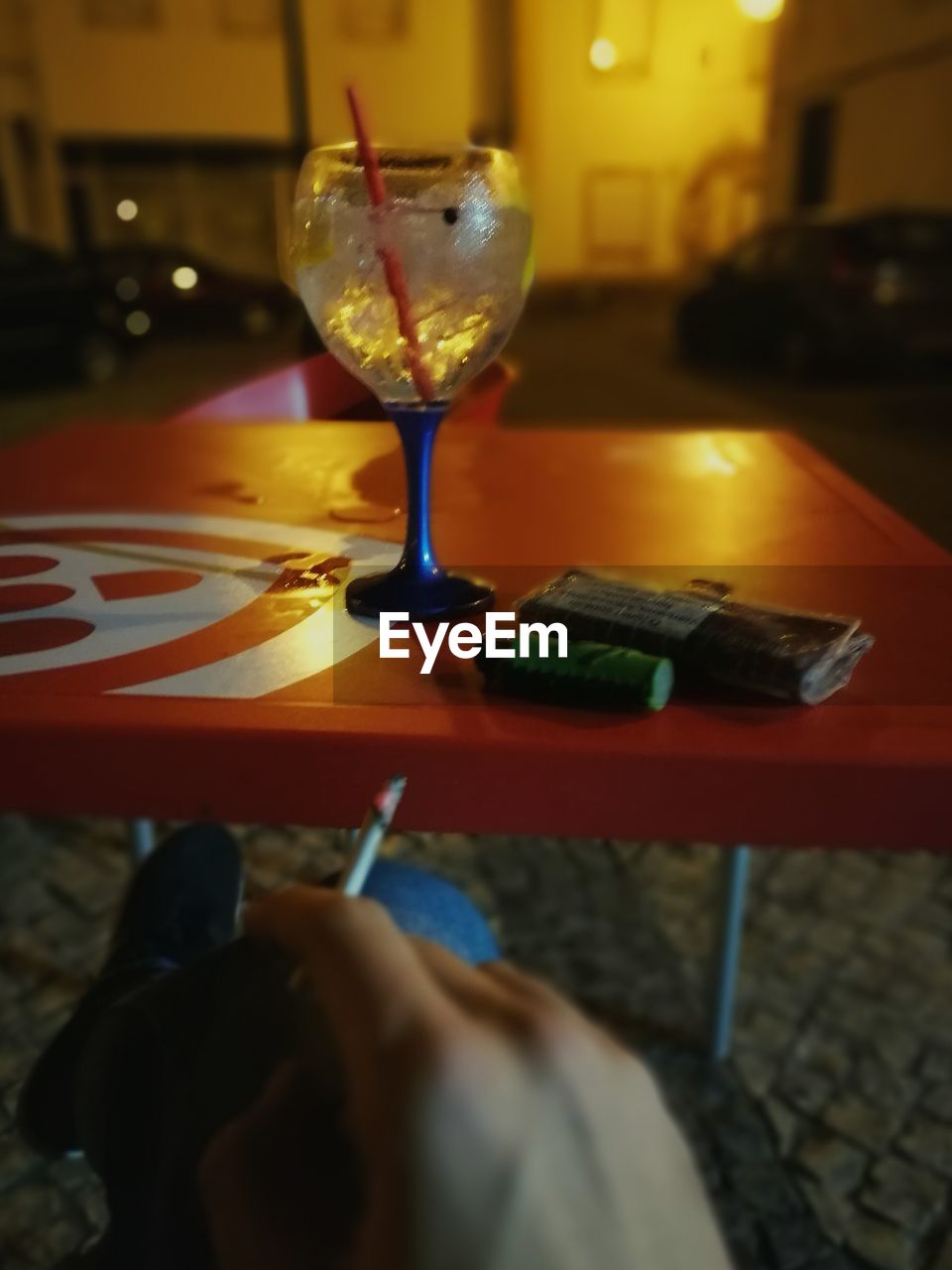 CLOSE-UP OF DRINK IN WINEGLASS ON TABLE