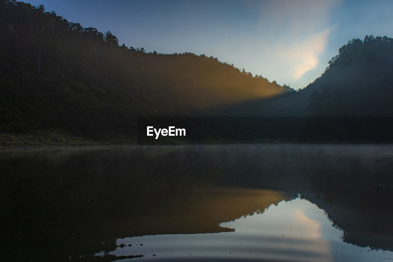 Scenic view of lake against sky during sunset