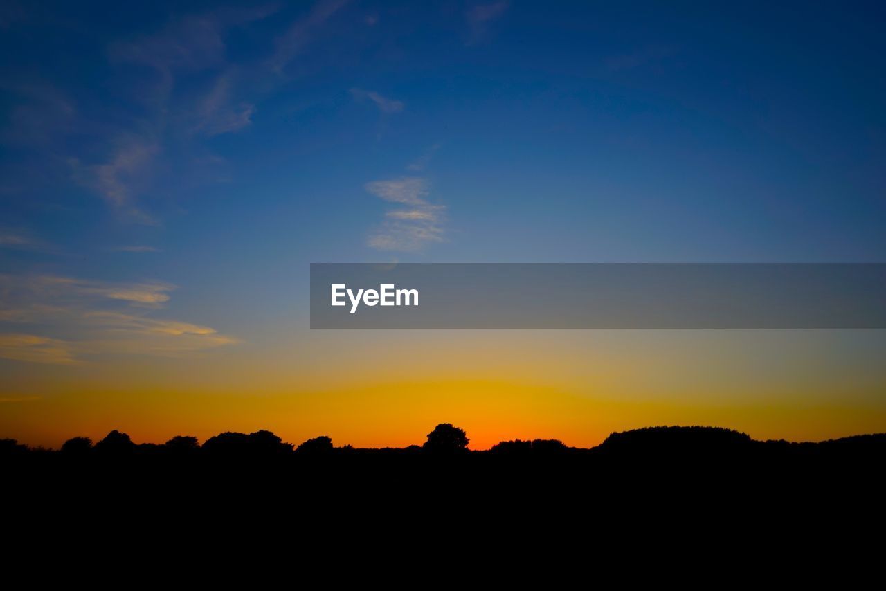 SILHOUETTE LANDSCAPE AGAINST SKY AT SUNSET