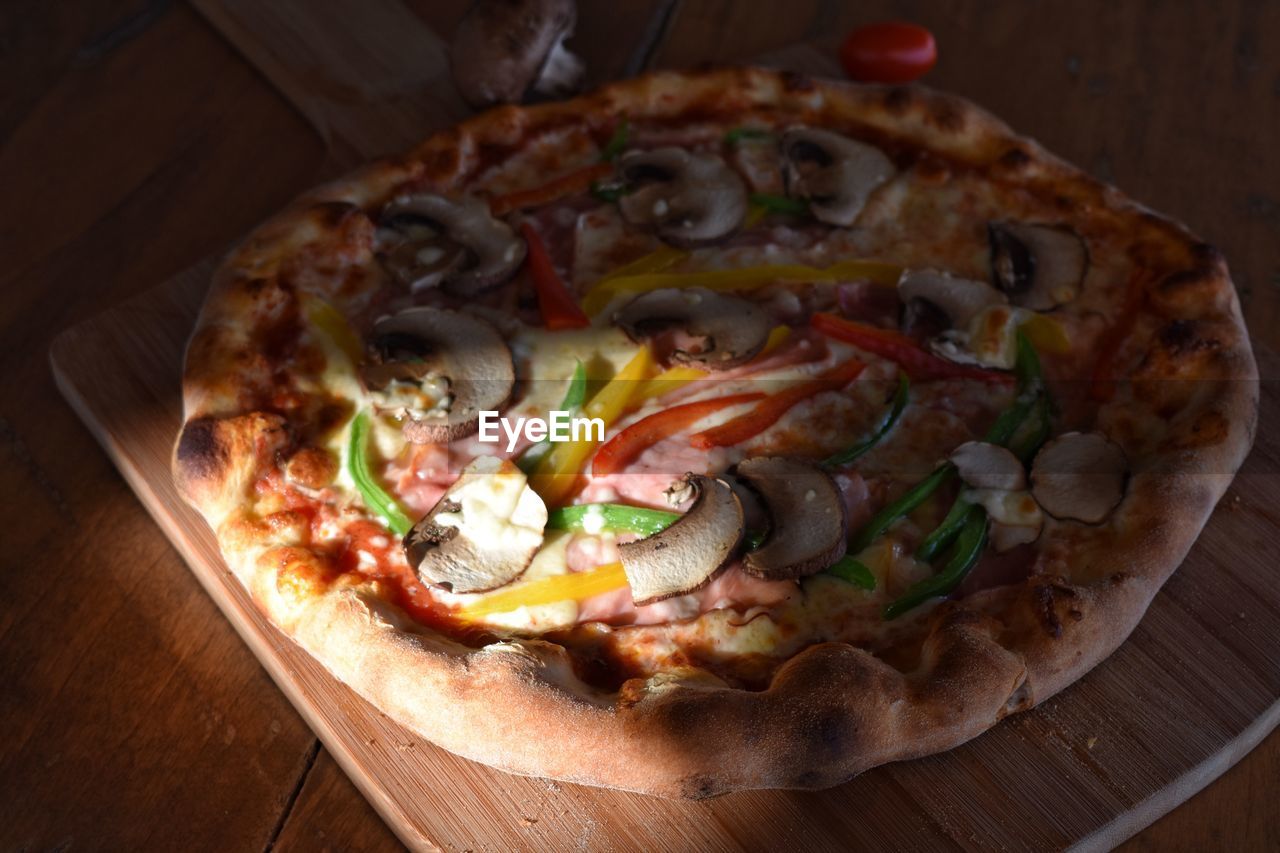 High angle view of pizza on cutting board