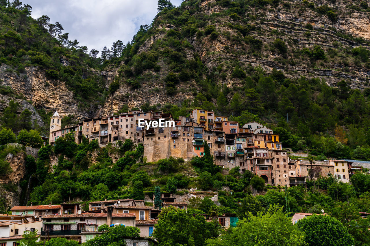 town, architecture, building exterior, built structure, village, building, mountain, tree, plant, tourism, nature, vacation, city, travel destinations, land, residential district, travel, house, history, environment, no people, the past, landscape, sky, outdoors, scenics - nature, beauty in nature, high angle view, mountain range, ancient, day, cityscape, old, community, religion, water