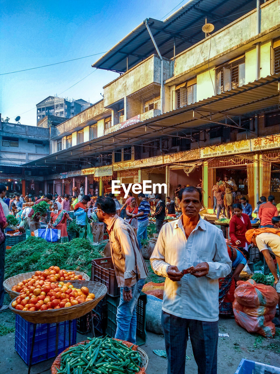 GROUP OF PEOPLE AT MARKET STALL