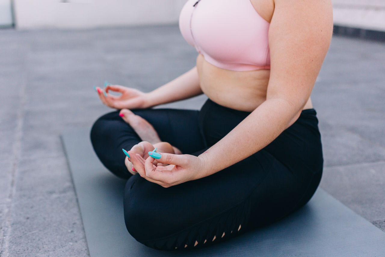 Low section of woman sitting outdoors