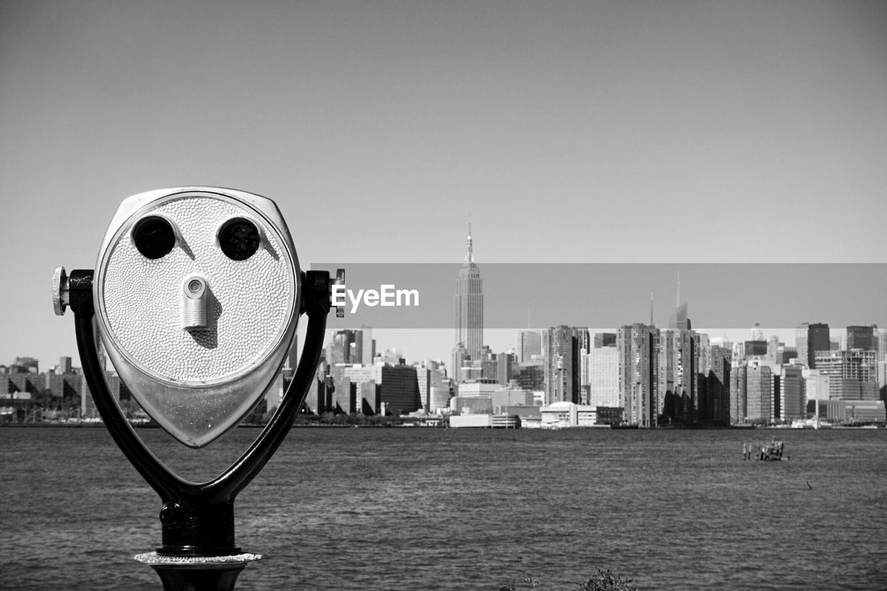 Coin-operated binoculars against cityscape