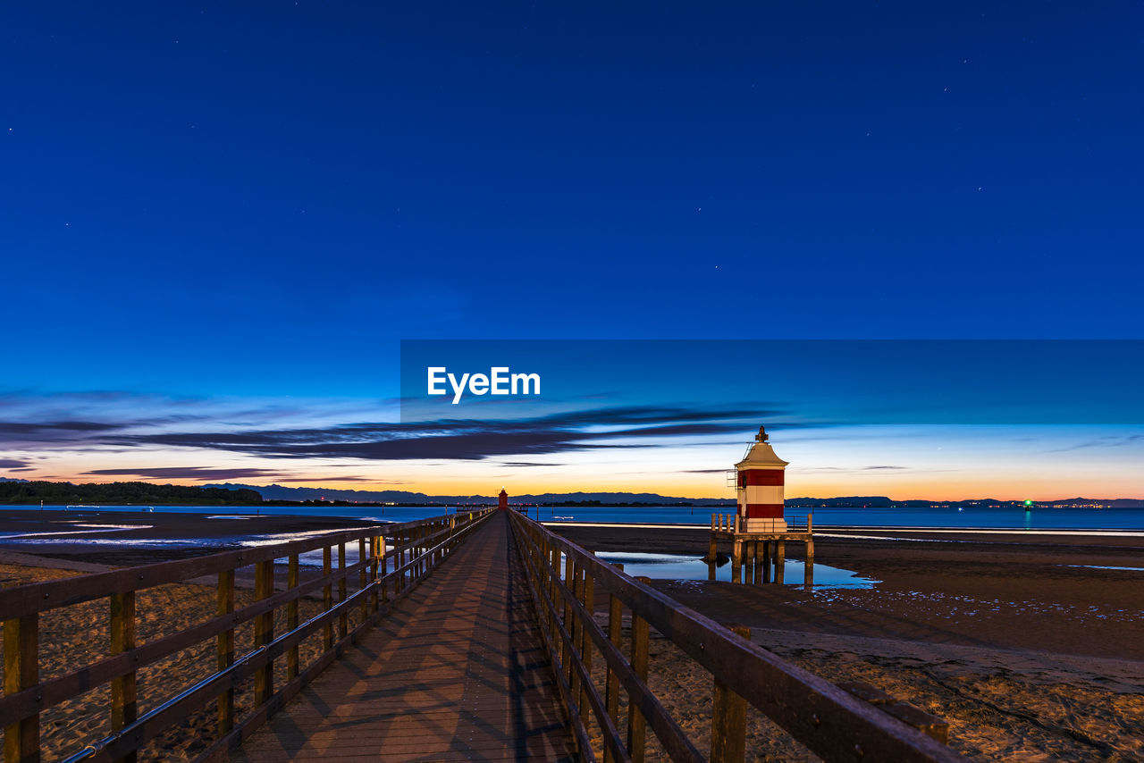 Scenic view of beach against blue sky