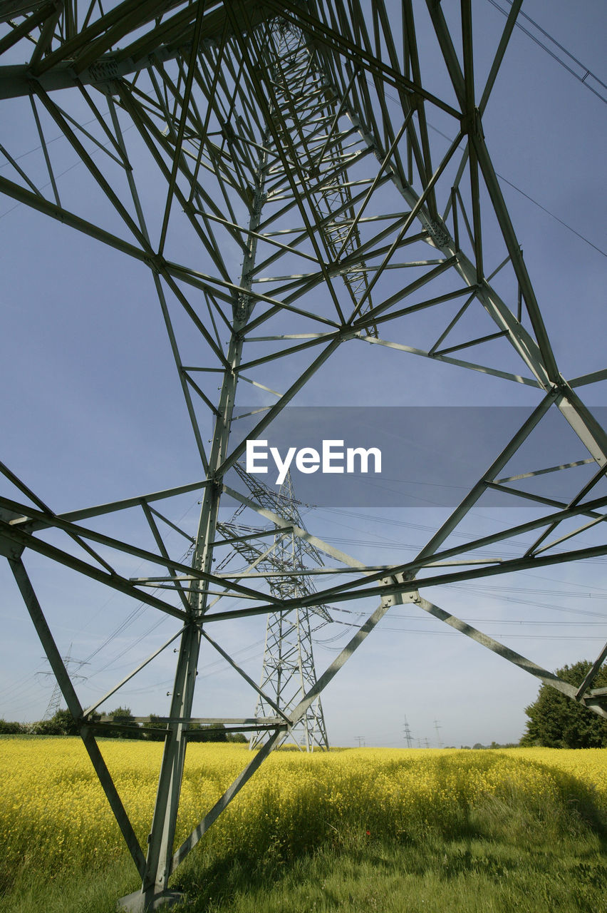 LOW ANGLE VIEW OF ELECTRICITY PYLON ON LAND