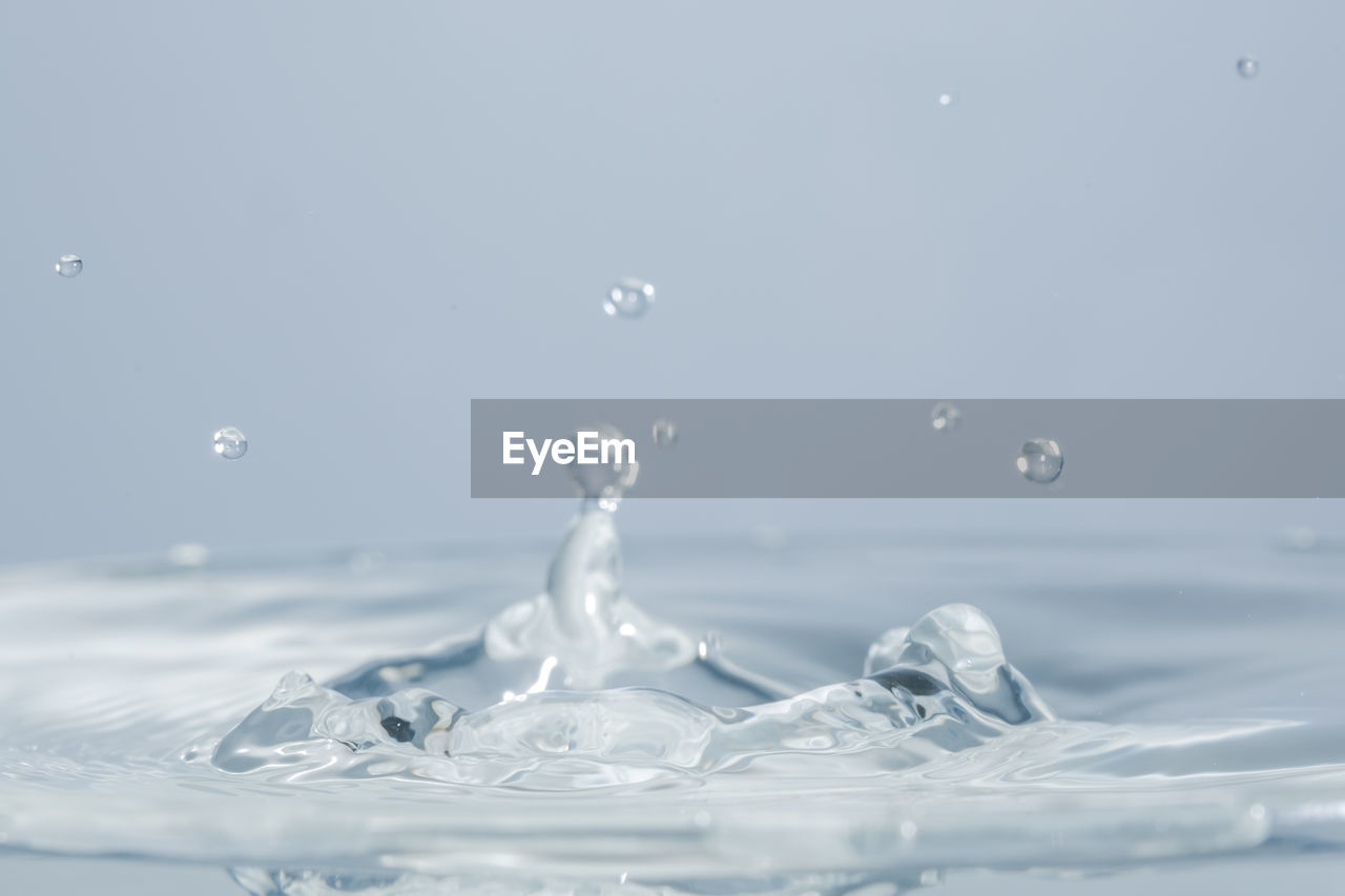 Close-up of water splashing against white background