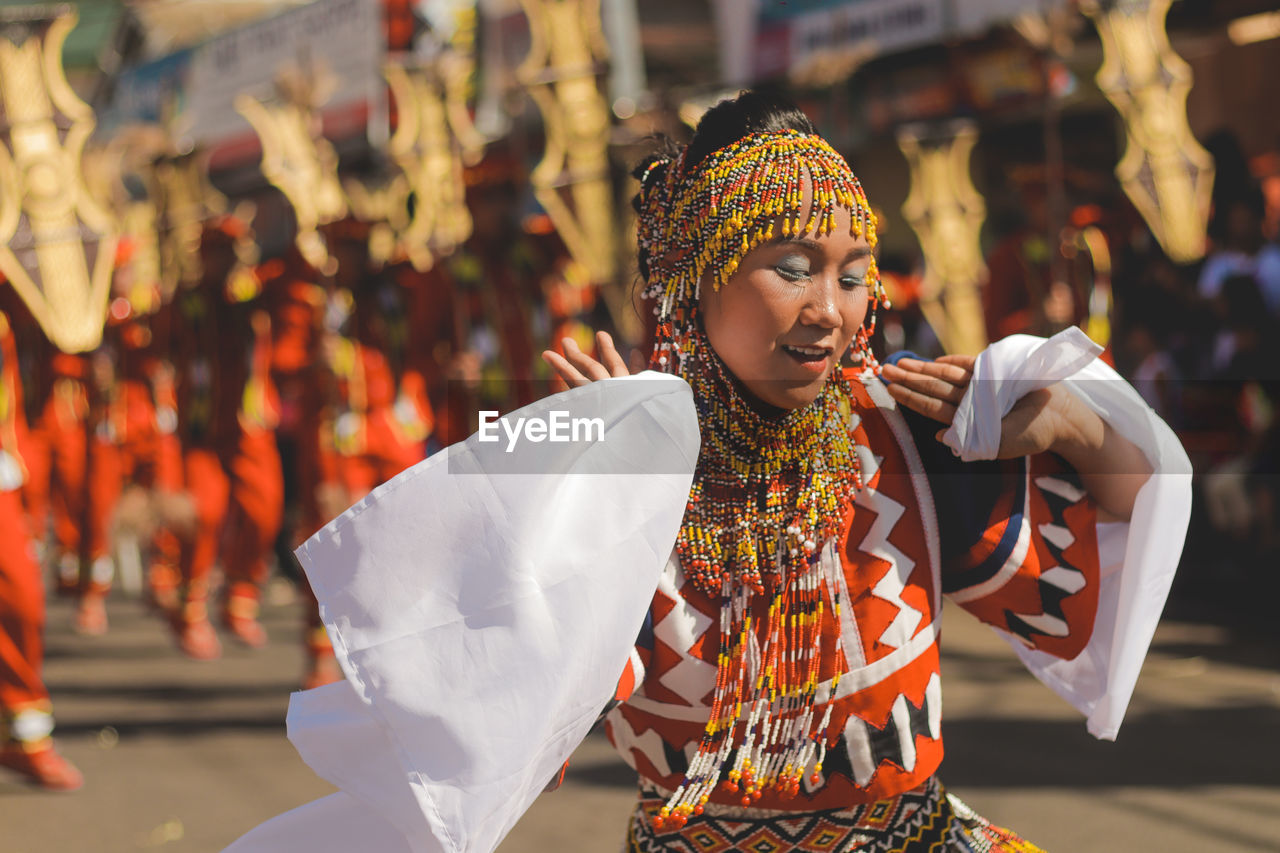 MIDSECTION OF WOMAN HOLDING TRADITIONAL CLOTHING