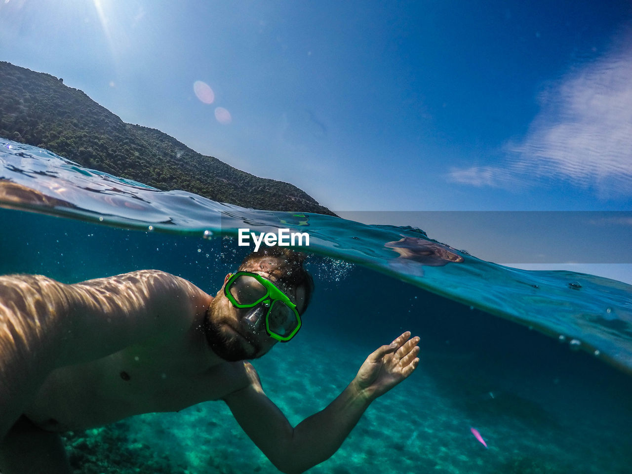 Close-up of young man swimming in sea