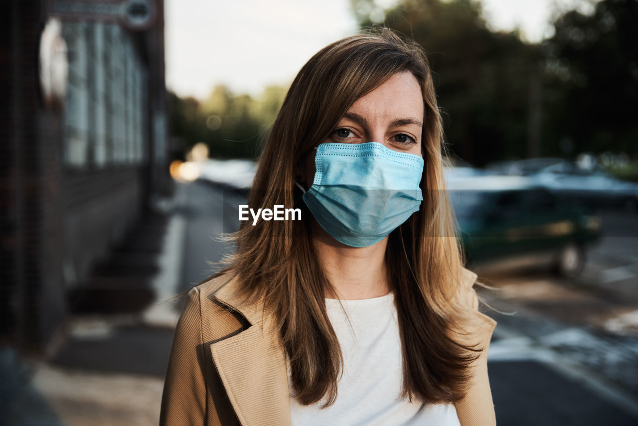 Woman in protective mask at city street