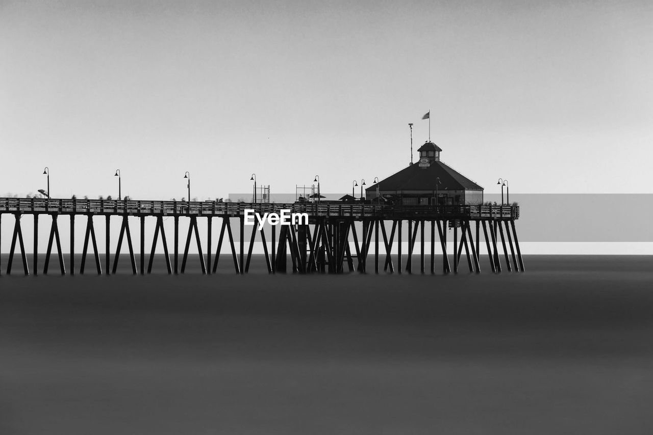 Gazebo on pier over sea against clear sky