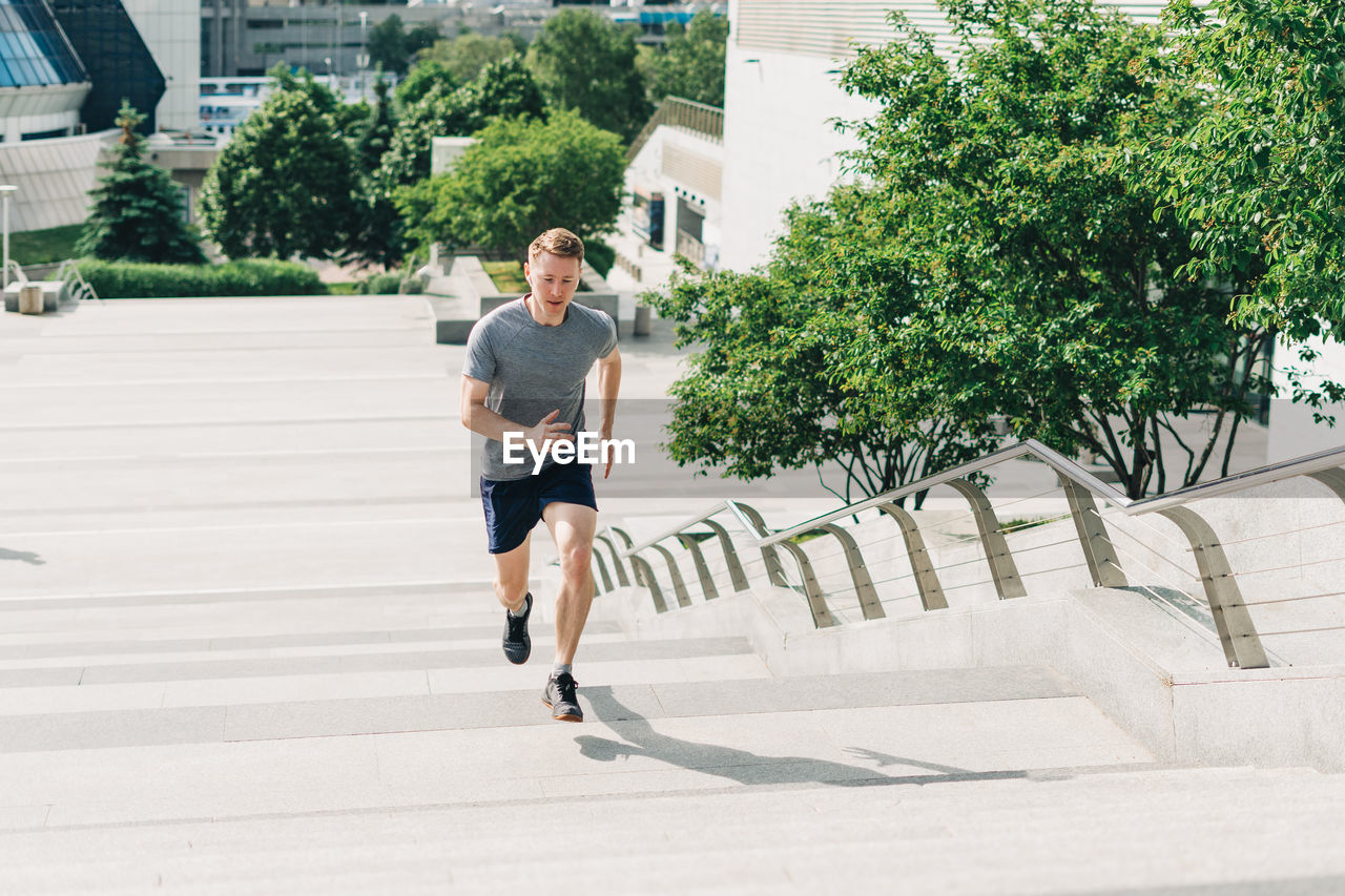 Male athlete jogging on staircase