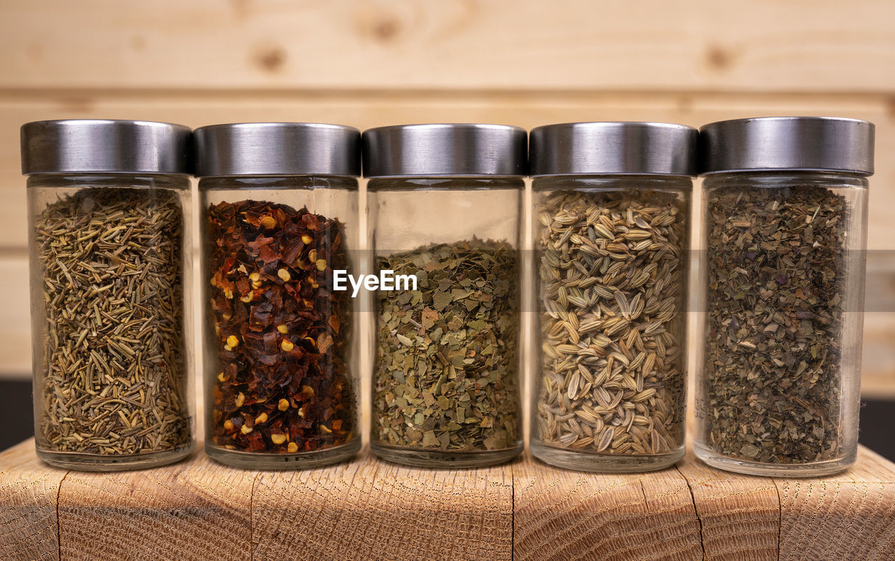 CLOSE-UP OF SPICES IN JAR ON SHELF