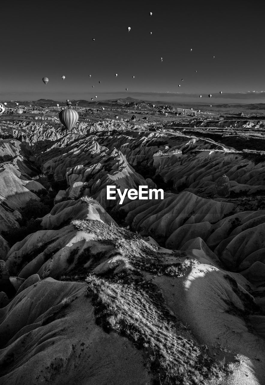 Scenic view of dramatic landscape with hot air balloon at cappadocia