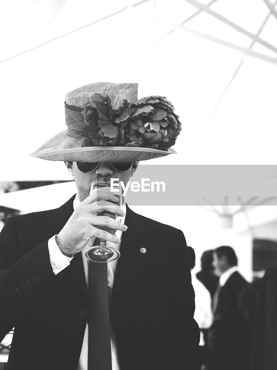 Young man drinking beer during wedding