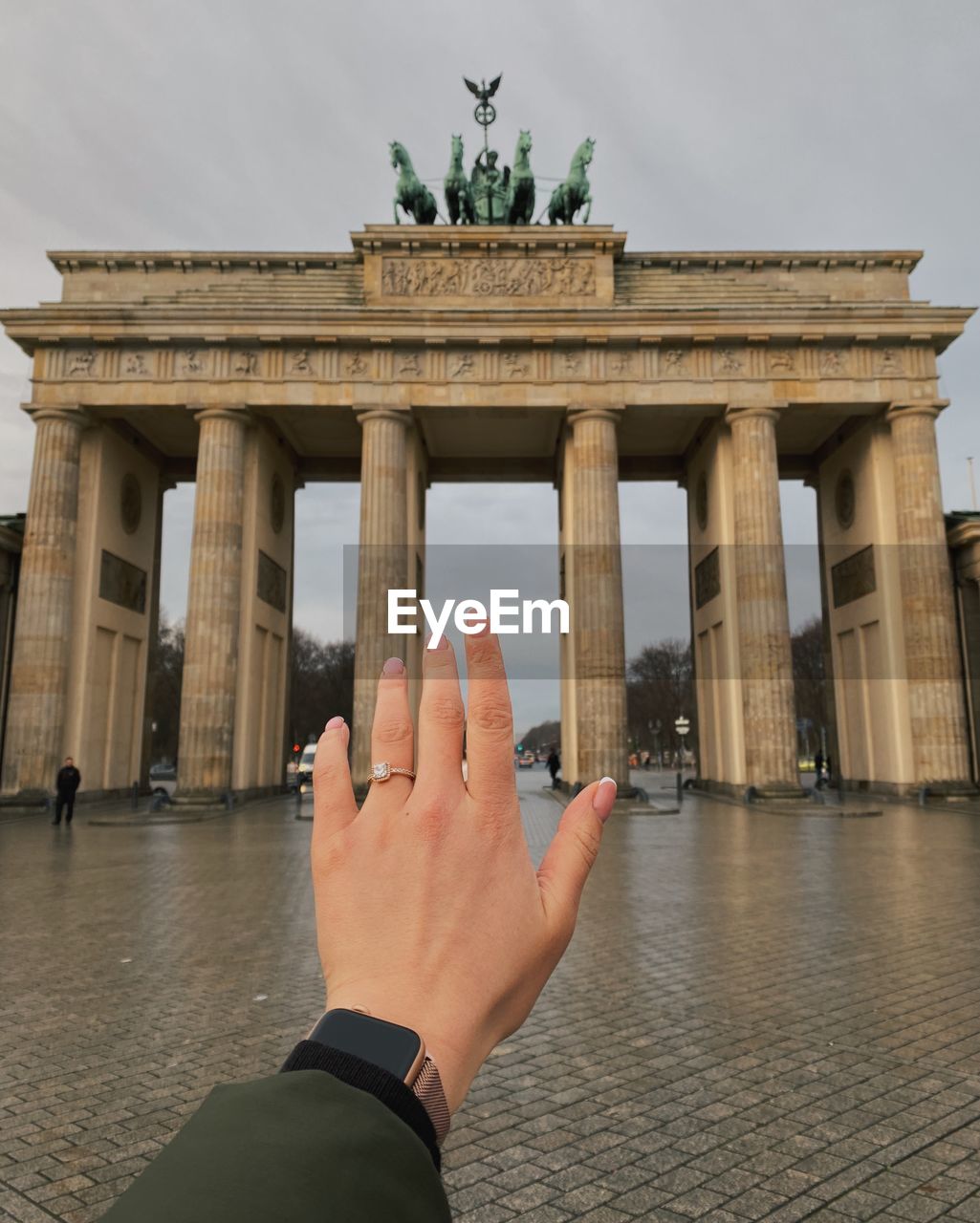 CROPPED IMAGE OF PERSON HAND HOLDING HISTORICAL BUILDING IN WATER