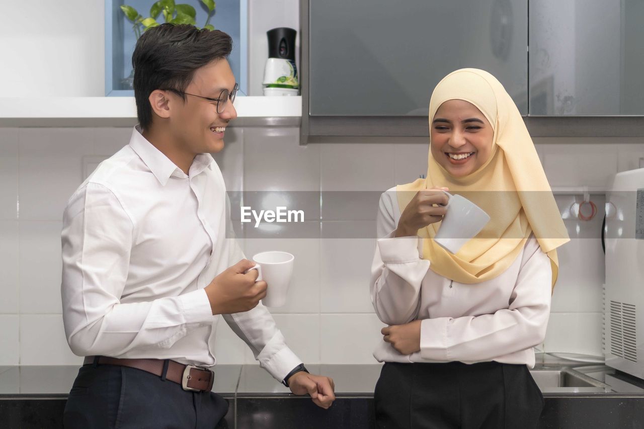 Colleagues talking in cafeteria